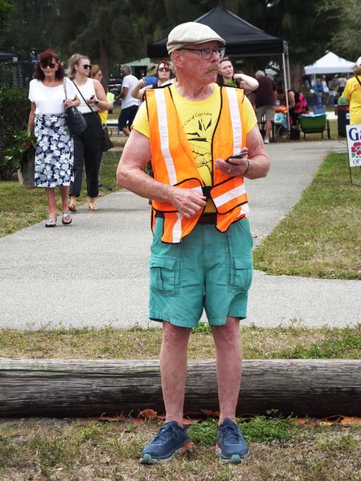 March in the Park 2022 garden club of cape coral member with orange safety vest